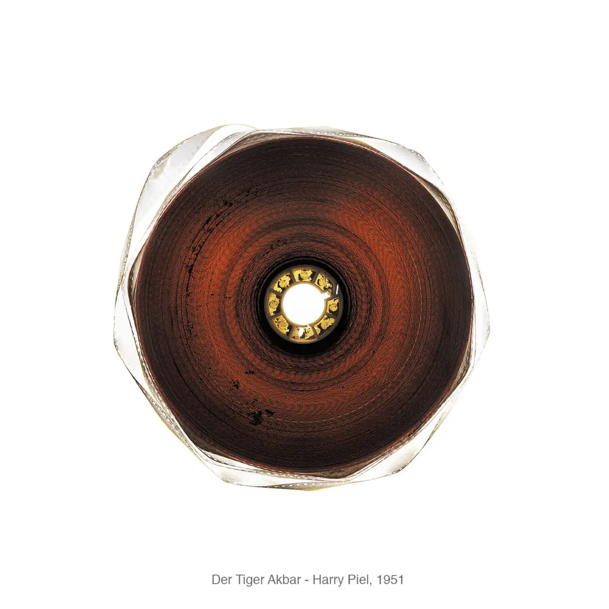 Top-down view of a rusted circular metal chamber with concentric rings and a central gold gear-bearing.