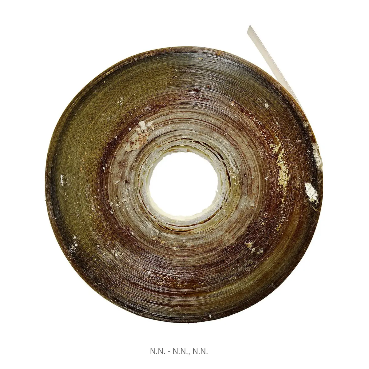 Close-up of a rusted circular metal disk with concentric grooves and a hollow center on a white background.