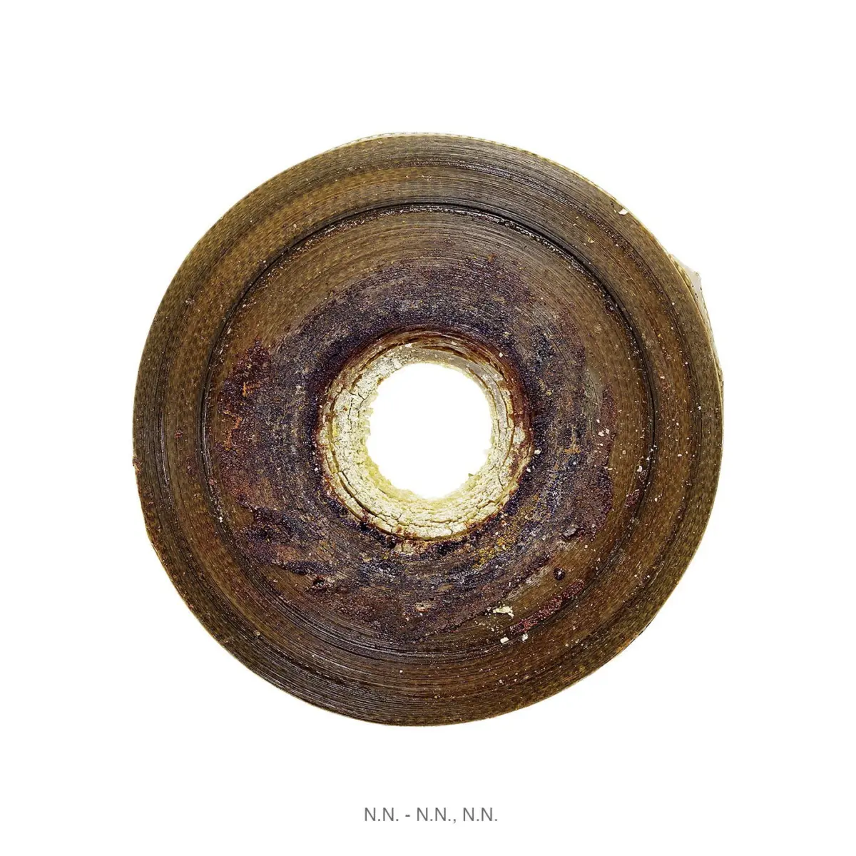 Rusty circular metal disk with concentric rings and a central hole on a white background.