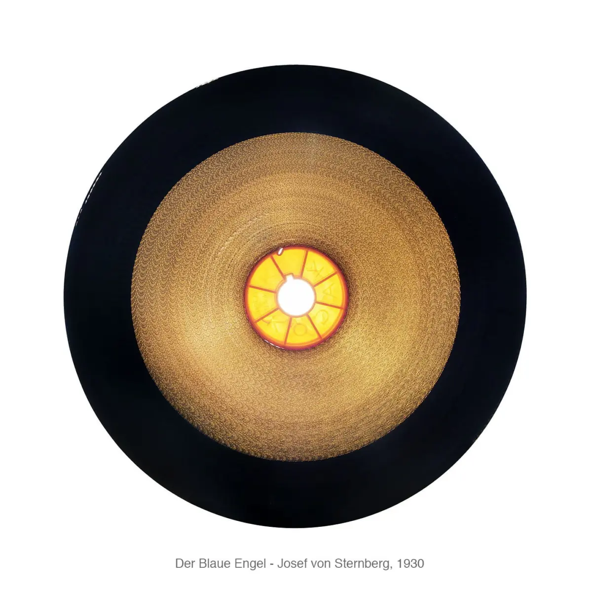 Top-down view of a circular pendant light with a gold textured interior and orange center, surrounded by a black outer ring.