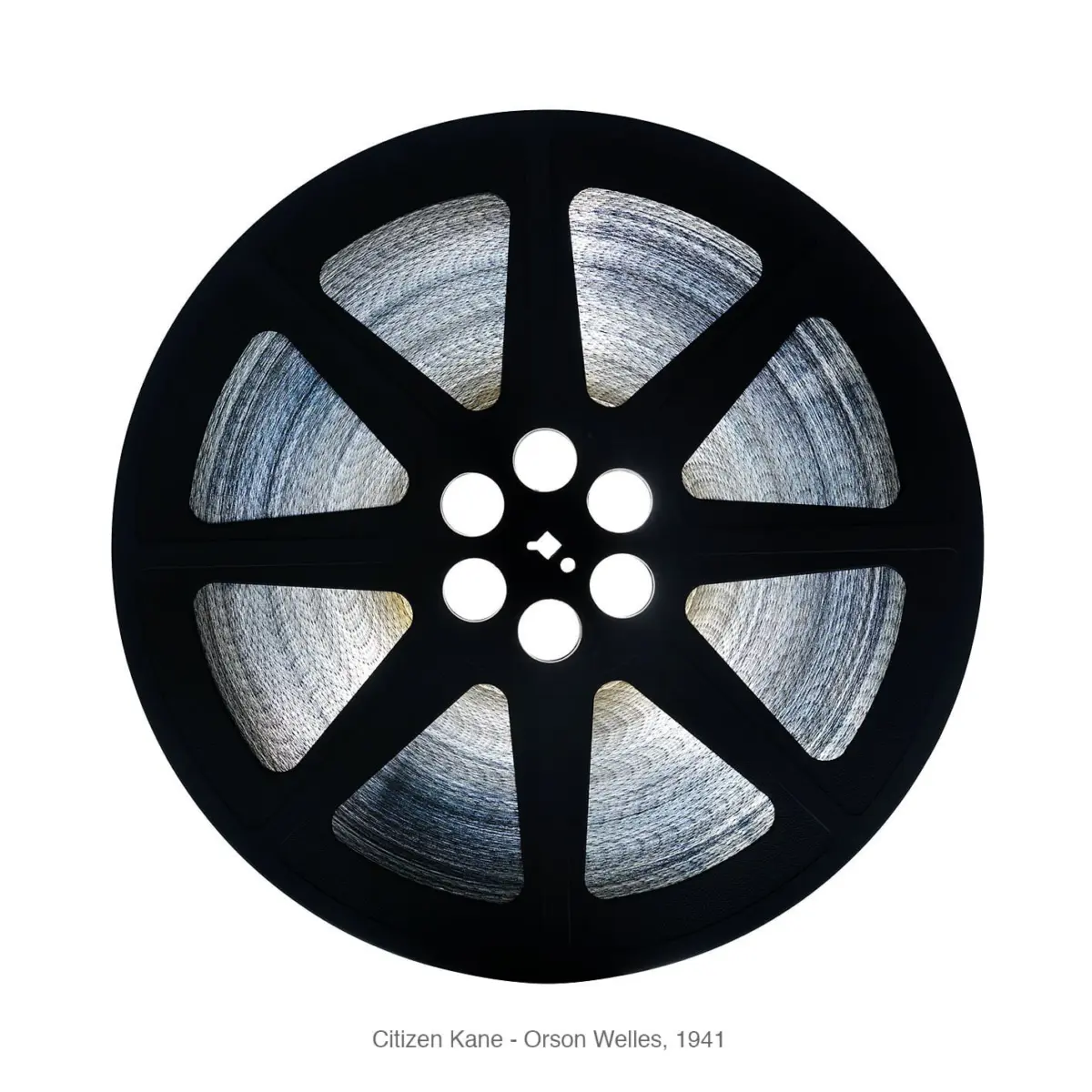 Front-on view of a black film reel with wound gray film against a white background.