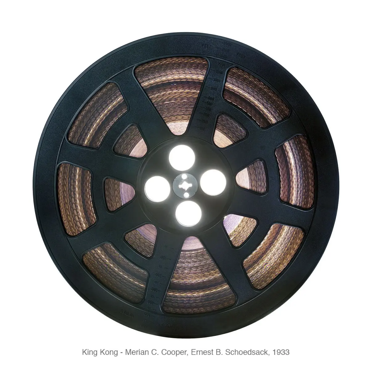 Close-up of a black film reel with copper-colored film wound around a central hub and bright lights in the center on a white background.