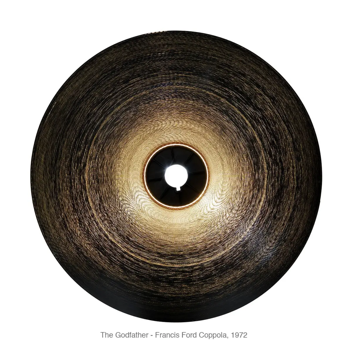Overhead view of a circular woven pendant lamp glowing from within