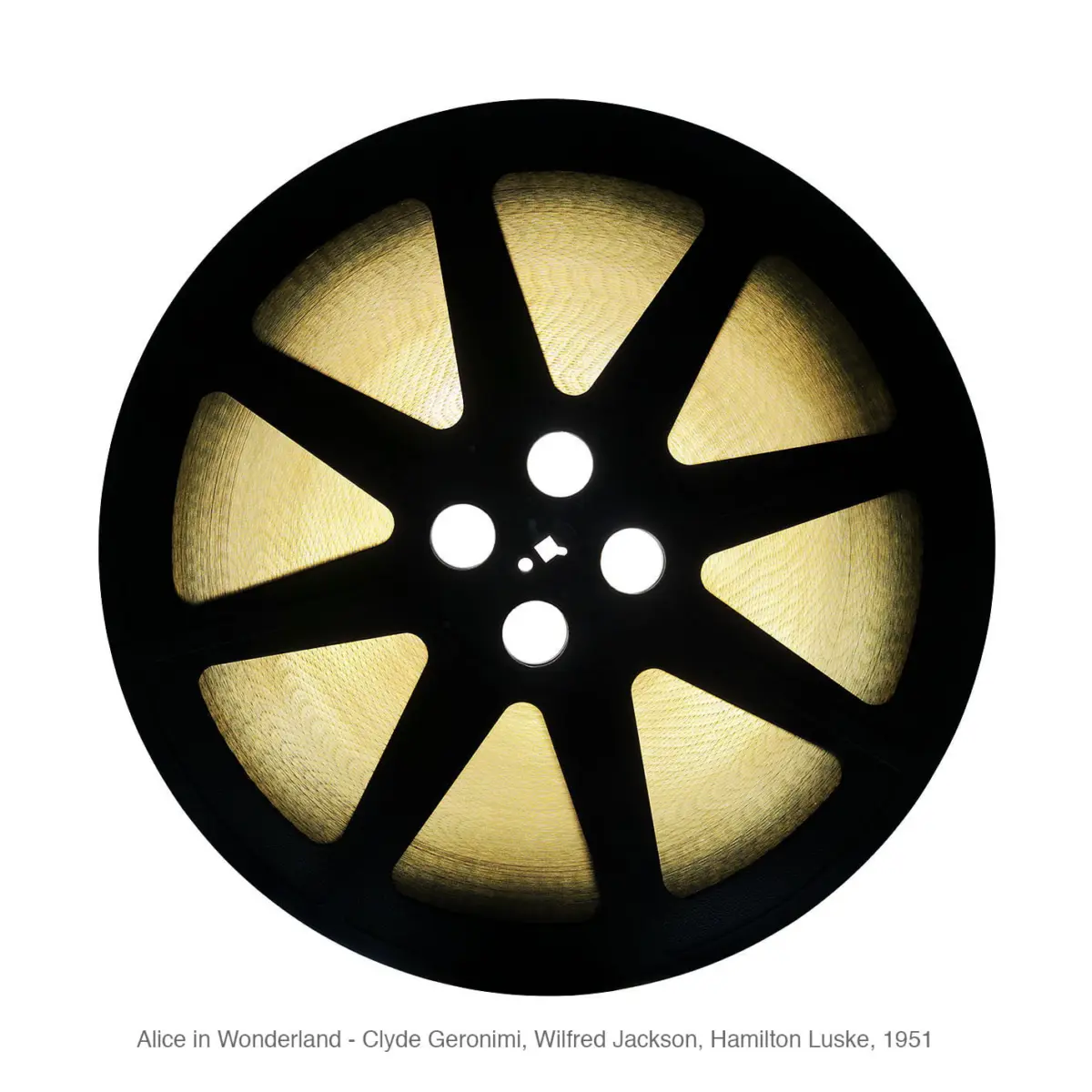 Close-up of a black film reel with yellow film, backlit, against a white background.
