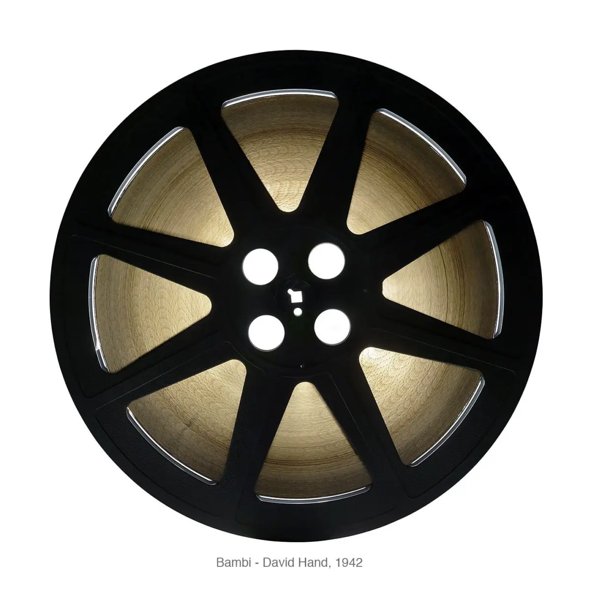 Close-up of a black film reel with gold film against a white background.