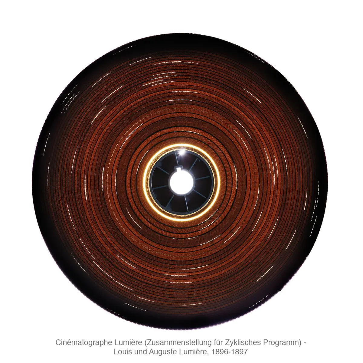 Circular red-brown disk with glowing central hub and concentric rings; close-up, studio lighting.
