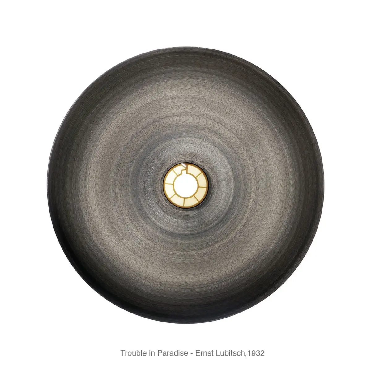 Top-down view of a large circular gray textured lampshade with a small illuminated central bulb.