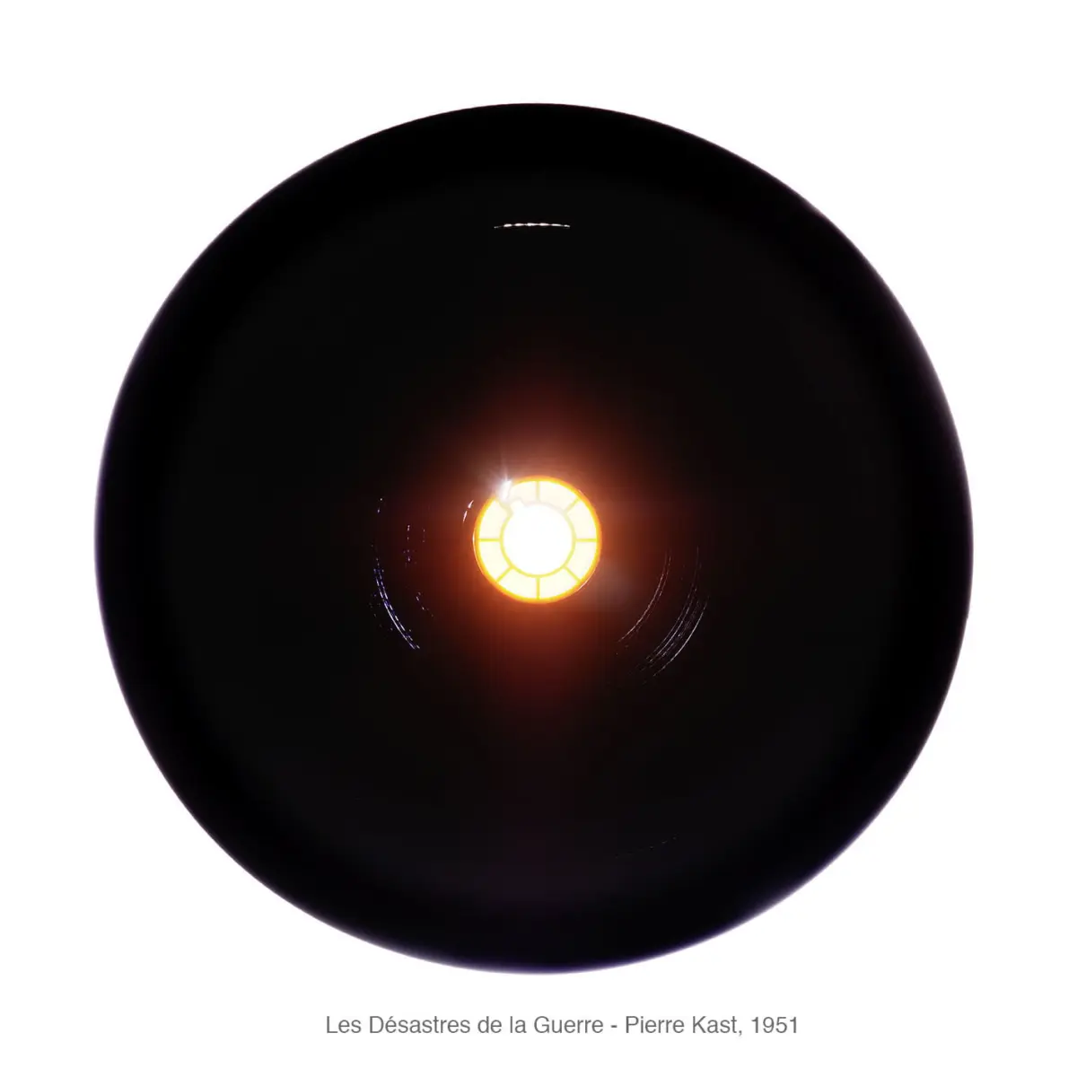 Close-up of a black circular disk with a glowing orange segmented core.