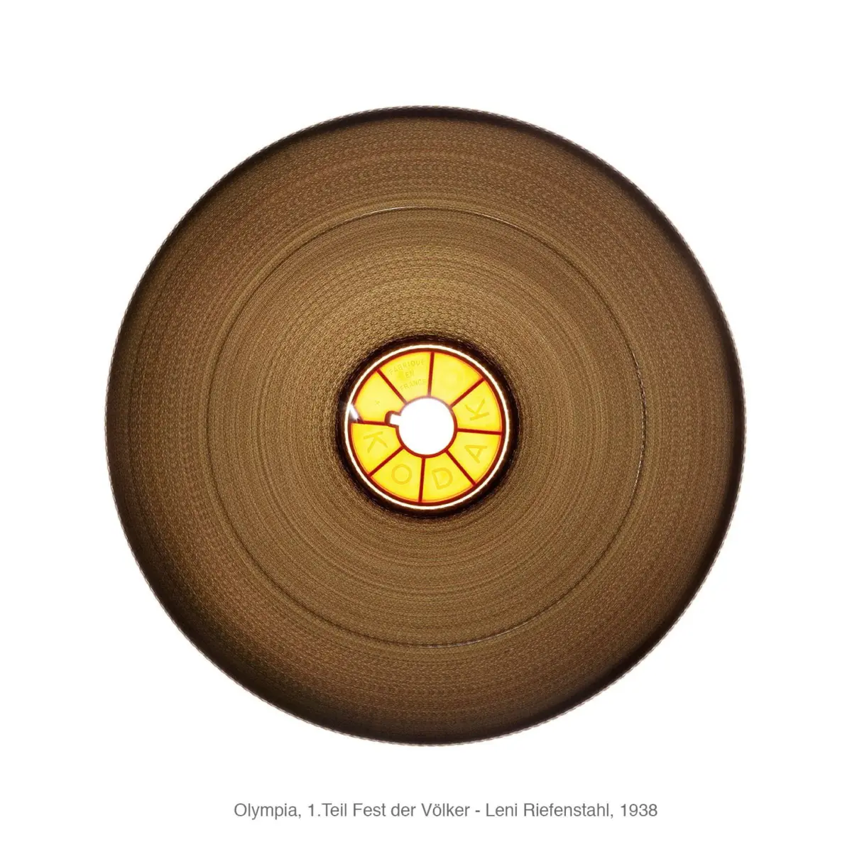 Close-up of round bronze lampshade with amber glass center, wheel segmented with the word KODAK.