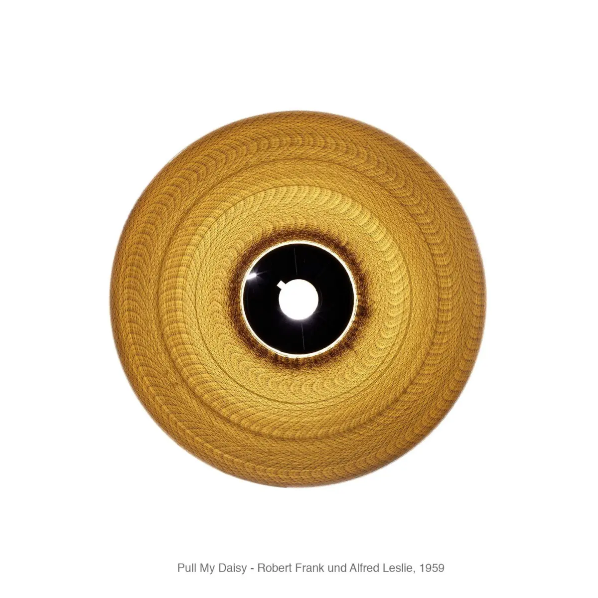 Top-down view of a circular woven straw hat with a dark center against a white background.