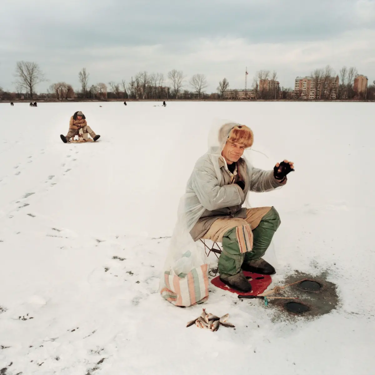 Ice fishermen on an ice floe at the city pond in Ivano - Frankivsk