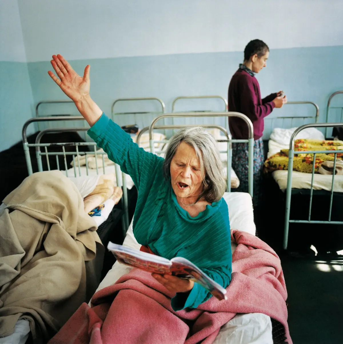 A woman reads from a notebook for hours in the psychiatric clinic in Ivano-Frankivsk