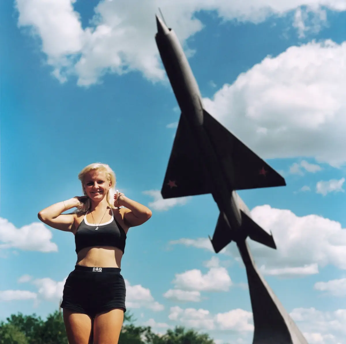 Young Ukrainian woman in front of a communist monument (Suchoi) in the industrial city of Krasnodon.