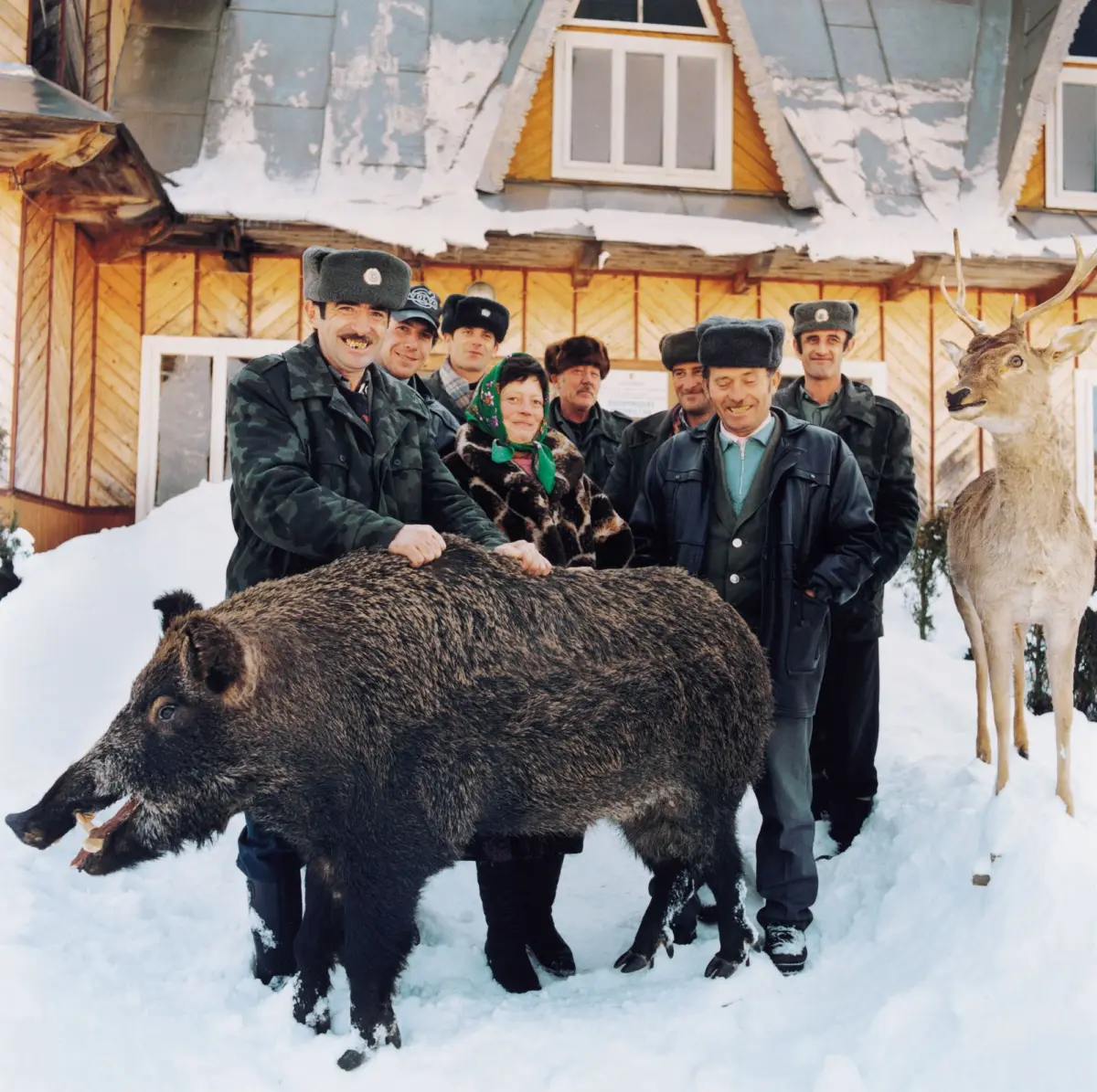 Forestry workers with stuffed hunting trophies in front of the forestry office in Polanitsa in the Carpathians.