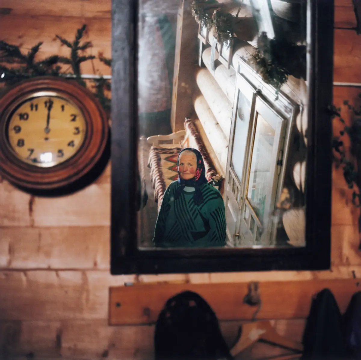 Hutsul woman in the mirror inside her house in the Carpathian mountains