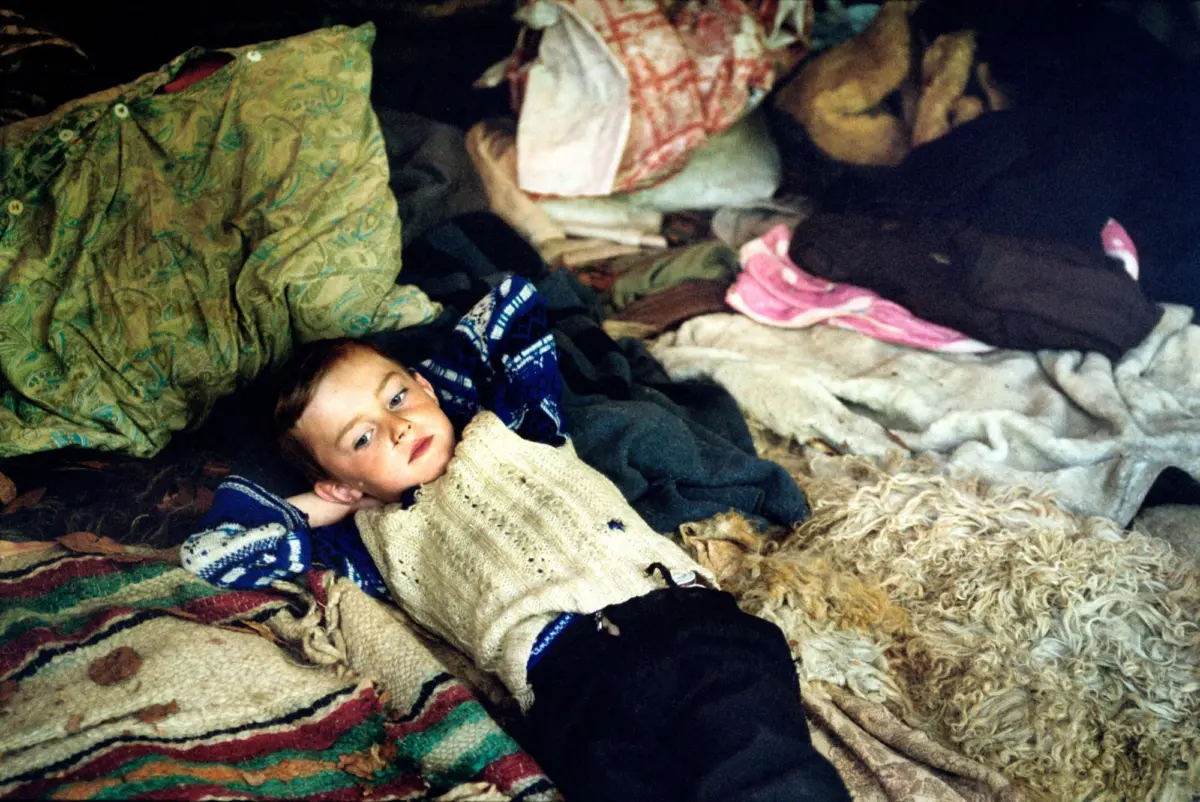 Young boy in a hut at the "Great Measure" festival
