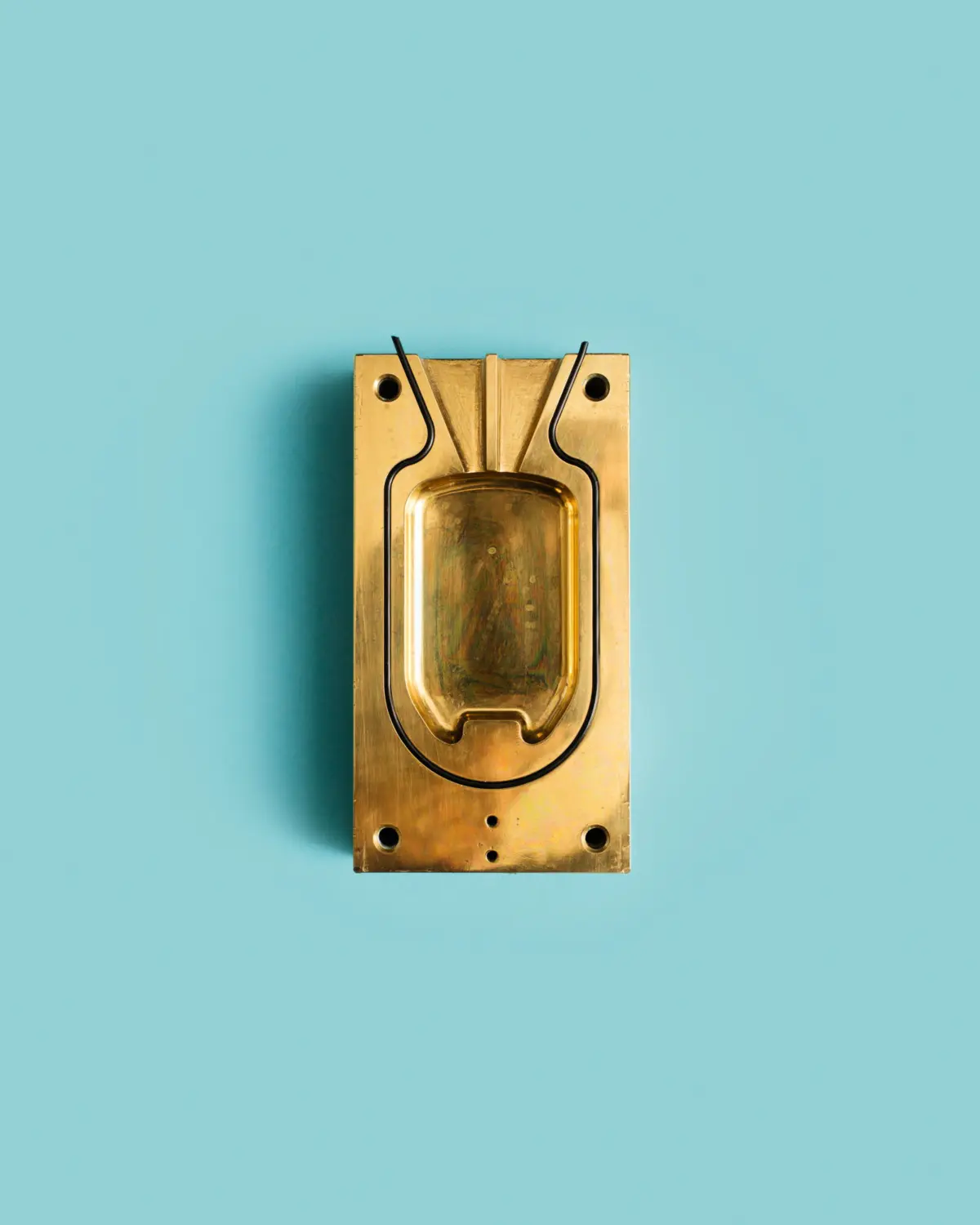 Brass mould for the encapsulation of implants, used to protect the relevant electronic circuits.